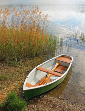  Lonely fishing boat at the lakesideの写真素材