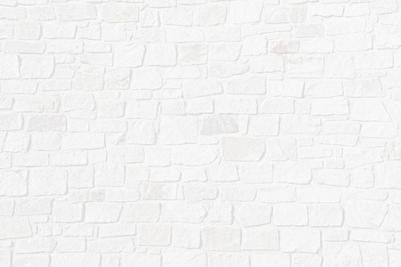 Light grey structured background with half transparent brick wall of natural rough stonesの写真素材
