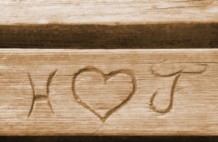  Initials of a love couple, carved in a bench plank の写真素材