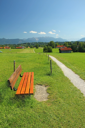 rural walkway and bench, pictorial bavarian landscape の写真素材