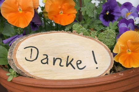 rustic signboard with handwritten thanks and viola flowers 