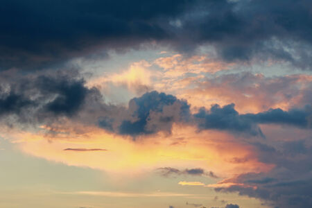 beautiful sunset sky with grey clouds and orange lighting