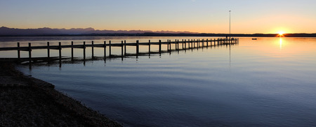 starnberg lake and boardwalk at sunset, tranquil sceneryの写真素材