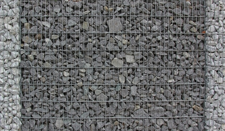 gabion fence filled with granite stones, easy care garden fenceの写真素材