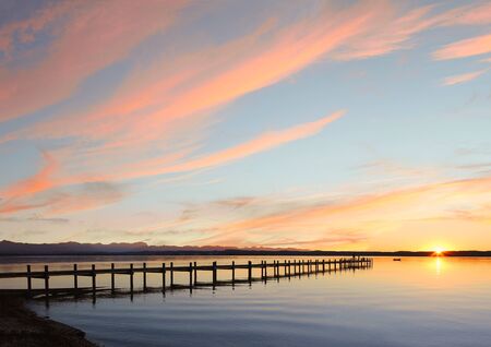 lake starnberg and mountain range, sunset sky background with copy spaceの写真素材