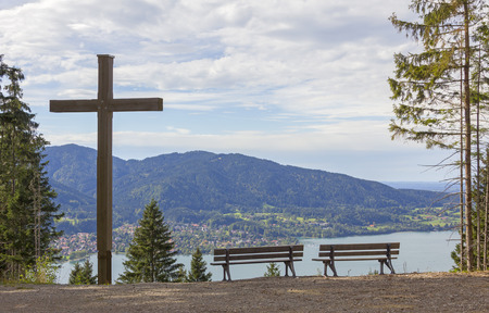 lookout point with wooden cross and benches, lake tegernsee, bavariaの写真素材