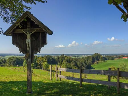 rural bavarian landscape with christian wayside crossの写真素材