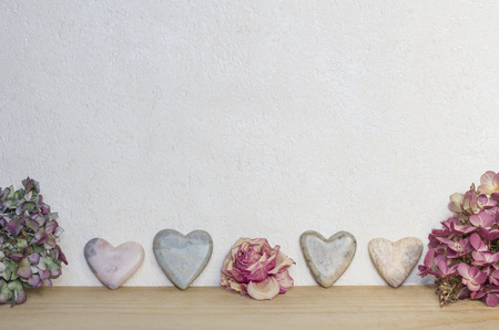 marbled background with soap stone hearts and dried hydrangea and rose flowersの写真素材