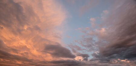 beautiful sunset scenery with blue sky, pink orange and grey clouds
