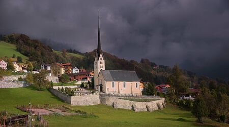 mountain village seewis in switzerland, autumnal landscape and dramatic sky