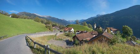 alpine road through mountain village luzein in the swiss alpsの写真素材