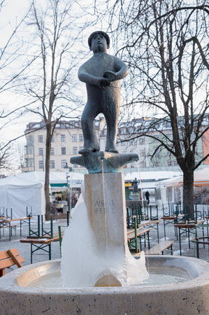 MUNICH, BAVARIA, GERMANY, February 28th, 2018 - fountain WEISS FERDL statue, a famous bavarian comedian and folk singer, located on Viktualienmarkt munich. winter scene.のeditorial素材