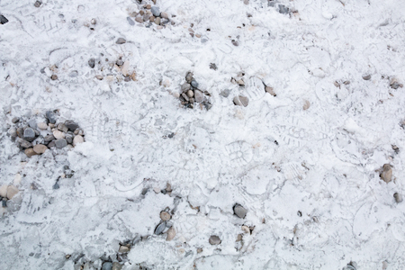 frosty ground with pebble stones backgroundの写真素材