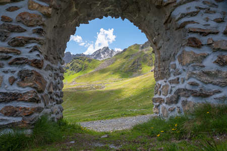 view through stone arch to beautiful mountain landscape Parsenn, swiss alps above Davosの写真素材