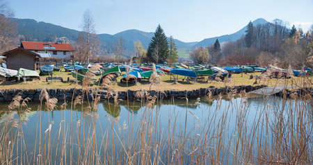 Schlierach river at early springtime. view to reversed boats and upper bavarian alpsの写真素材