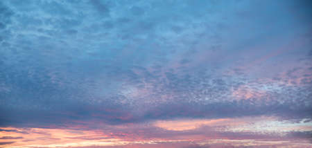 evening sky scenery with fleecy clouds pink and blue