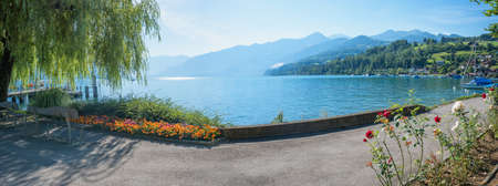 idyllic lakeside promenade tourist destination Faulensee, lake Thunersee switzerland.