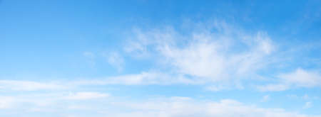 sky panorama background light blue with soft fluffy clouds and copy spaceの写真素材