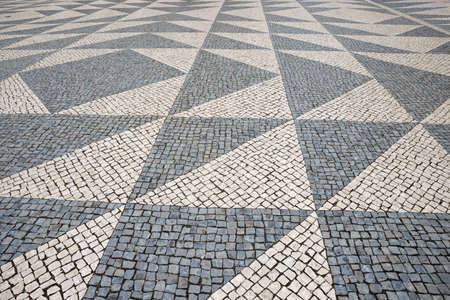 cobblestone pavement in gray tones, with triangular pattern, architectural backgroundの写真素材