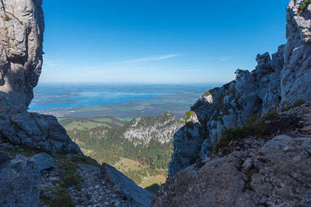 rock passage at Kampenwand mountain, view to lake chiemsee and blue sky, upper bavariaの写真素材