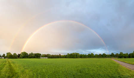 double rainbow over the fields, on the outskirts of Hohenkirchen village, panorama landscape bavariaの写真素材