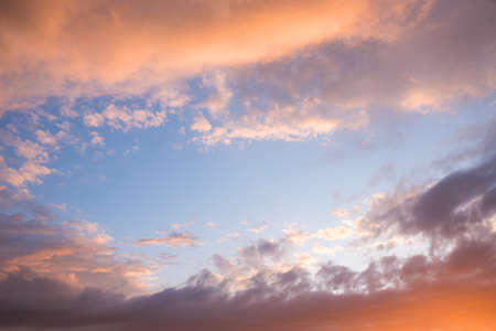 romantic sunset sky scenery with colorful clouds and blue middleの写真素材