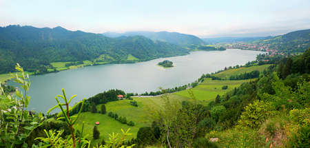 Hiking destination Hohenwaldeck, view to lake Schliersee and green bavarian landscape, gray cloudsの写真素材