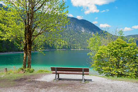 Walkway around lake Eibsee, Bavarian tourist resort, lookout place with bench