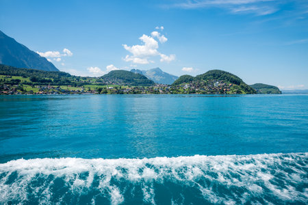 view from lake Thunersee boat trip to Spiez village, bernese oberland, switzerland. waves with whitecapの写真素材