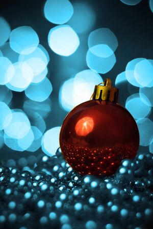 Christmas ornament lying on balls of a Christmas chain on a blurred background with lights.の写真素材
