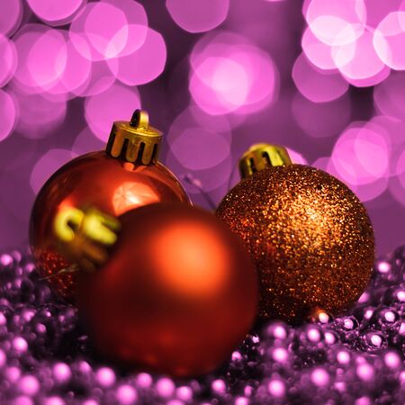 Christmas ornaments lying on balls of a Christmas chain on a blurred background with lights.の写真素材