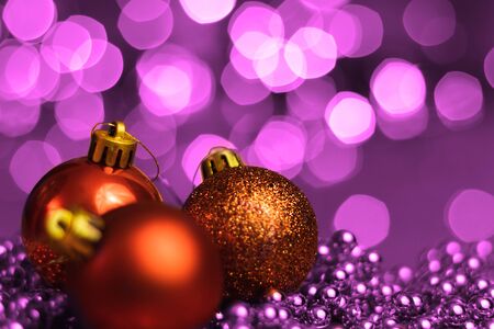 Christmas ornaments lying on balls of a Christmas chain on a blurred background with lights.の写真素材