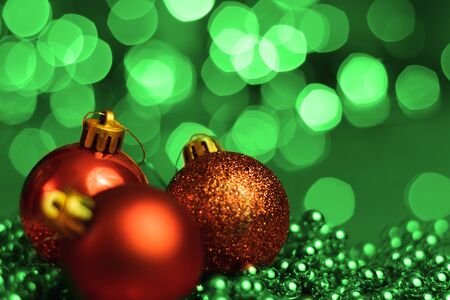 Christmas ornaments lying on balls of a Christmas chain on a blurred background with lights.の写真素材