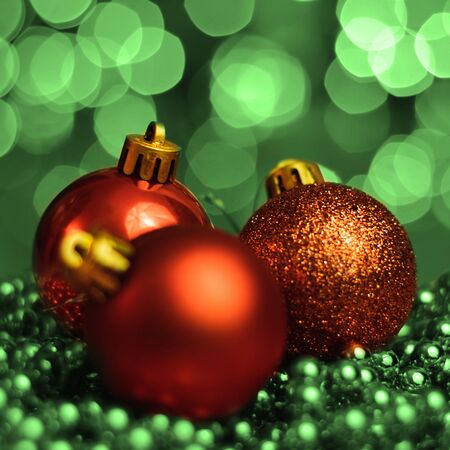 Christmas ornaments lying on balls of a Christmas chain on a blurred background with lights.の写真素材