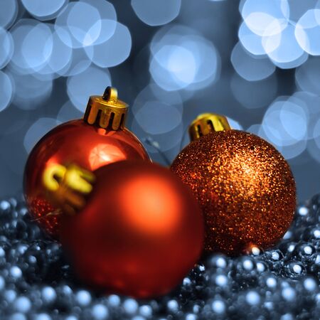 Christmas ornaments lying on balls of a Christmas chain on a blurred background with lights.の写真素材