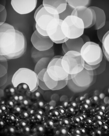 Christmas background, with blurred Christmas lights, beautiful bokeh and a chain of glossy balls in the foreground. Christmas decorationsの写真素材