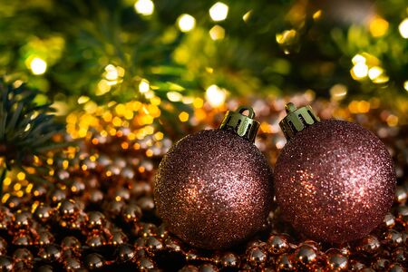 Christmas landscape with Christmas balls, chain, branches and lights. Beautiful colorful blurry christmas background.の写真素材