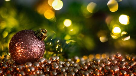 Christmas landscape with Christmas balls, chain, branches and lights. Beautiful colorful blurry christmas background.の写真素材