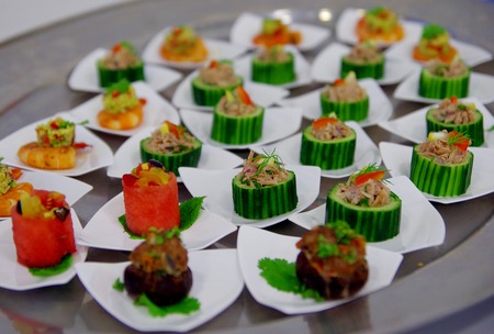 Close up of silver trail with a few kinds of canapés on itの写真素材