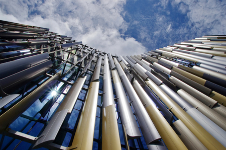 Bottom view of modern building in business area. Modern skyscraper close up. 
