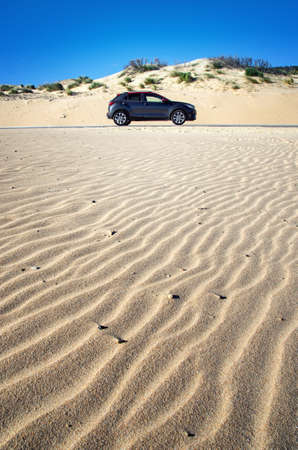 Traveling in the sandy road. Car in the desert. Adventure in the desert.の写真素材