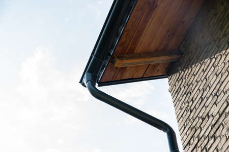 Close up of rain gutter system and guttering downspout pipe on the houseの写真素材