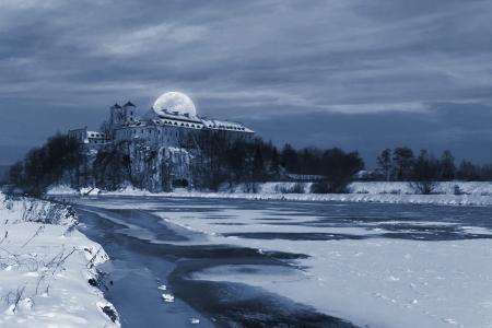 Big moon over the Benedictine Abbey  in Tyniec, near Krakow - winter viewの写真素材