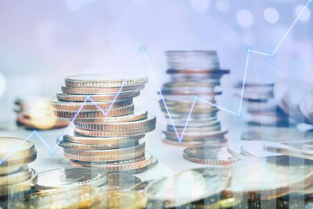 Graphs and rows of coins to communicate finance, investment, money collection and money management that have grown and have business value.の写真素材