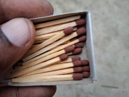 Wooden matches in a box on the background of cement wall.の写真素材