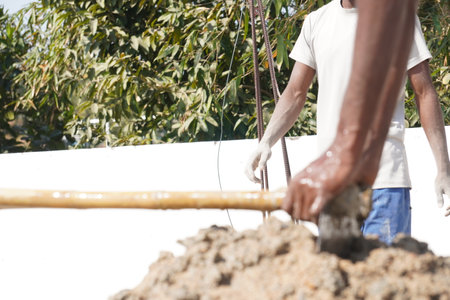 Workers are building the foundation of a new house in Thailand.