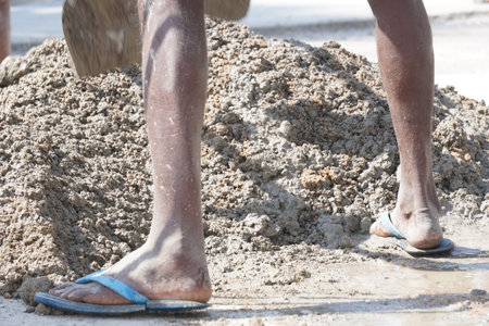 Worker at the construction site, closeup of feet and sandalsの写真素材