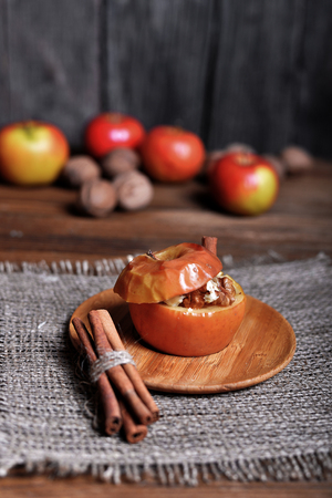 Baked apple with sugar and nuts. Selective focusの写真素材