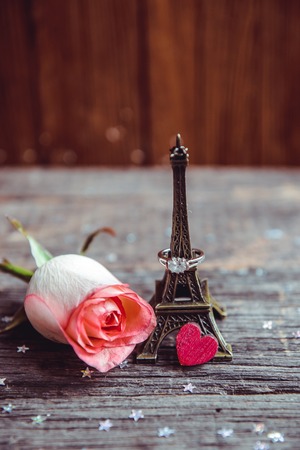 Declaration of love, the rose with a ring on a wooden board.の写真素材