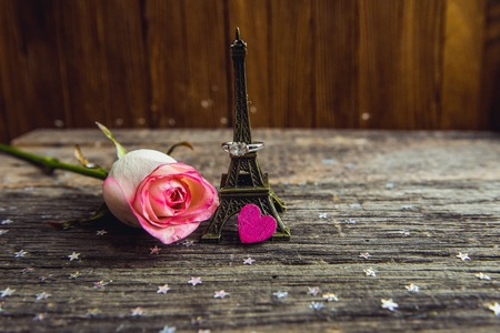 Declaration of love, the rose with a ring on a wooden board.